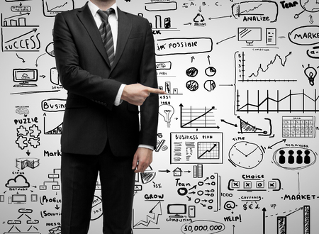 businessman standing and showing  finger to business strategyの写真素材