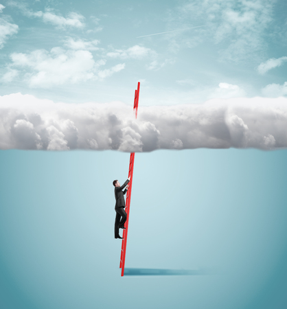 businessman standing on ladder and looking to cloudの写真素材