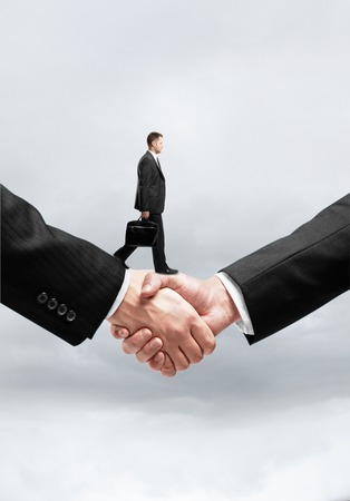 businessman walking on business handshakeの写真素材