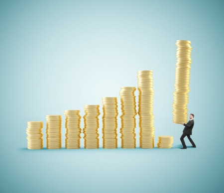 businessman with tower of coins with coinsの写真素材