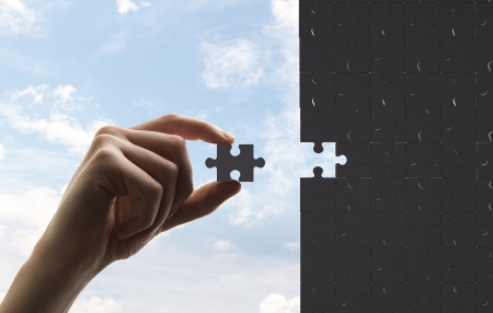 businessman built of puzzle on sky backgroundの写真素材