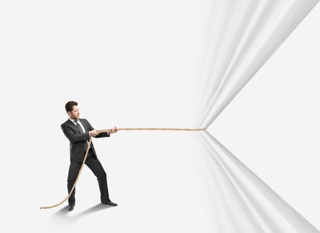 businessman pulling rope on a white backgroundの写真素材