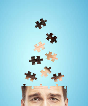 head businessman built of puzzle on blue background
