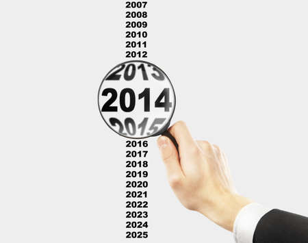 hand holdin magnifier over 2014 textの写真素材