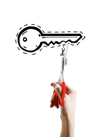 hand cut with scissors key on a white backgroundの写真素材