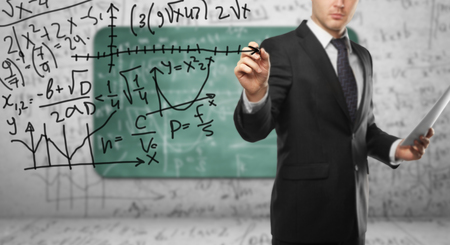 businssman drawing mathematical formula  in roomの写真素材