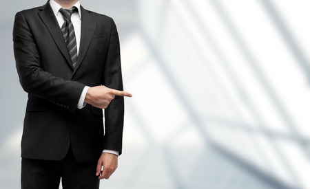 man showing something on a room backgroundの写真素材