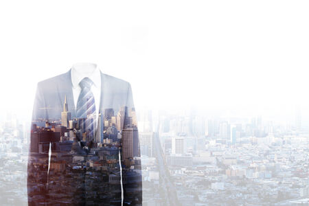 businessman without a head standing on city backgroundの写真素材