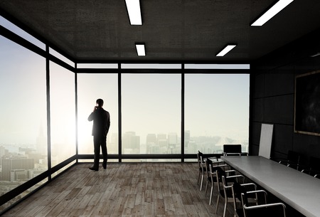 businessman in suit standing in officeの写真素材