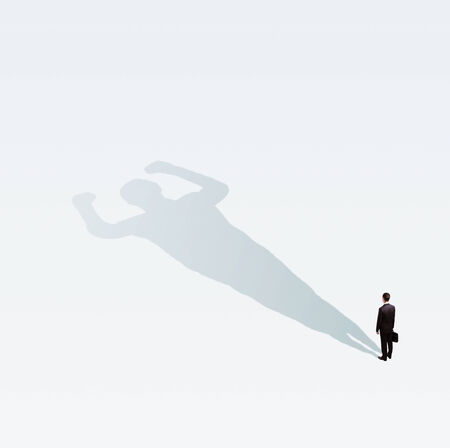 businessman concept with bodybuilder shadowの写真素材