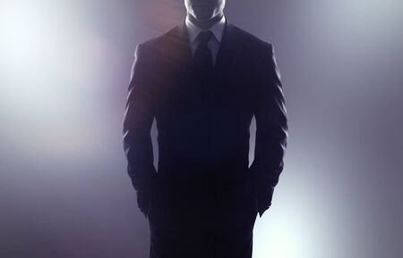 businessman in coat on a gray backgroundの写真素材