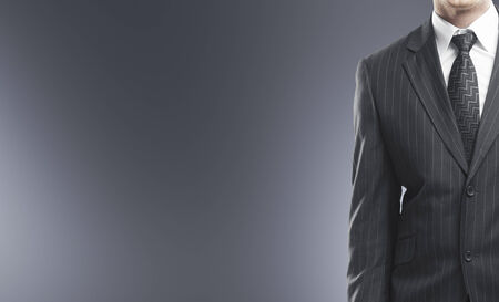 businessman in suit on a gray  backgroundの写真素材