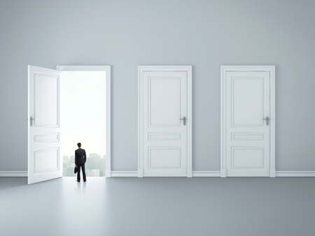businessman looking at opened door in room