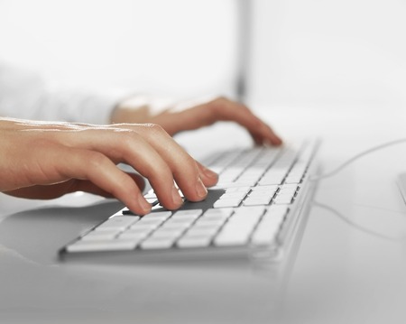 usienssman hands pushing keys of keyboard, close upの写真素材