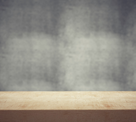 wooden desk and gray wall, close up