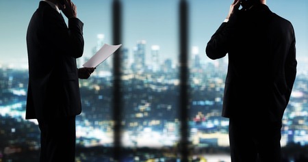 businesspeople working in night officeの写真素材