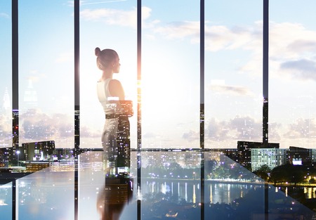 businesswoman thinking in office and looking to cityの写真素材