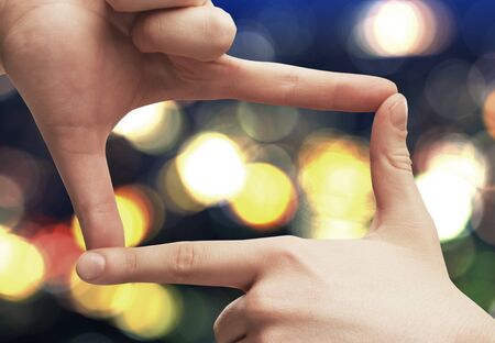 hands frame on a blured backgroundの写真素材