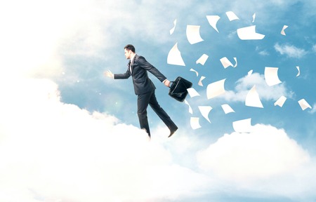 businessman jumping from cloud to another cloudの写真素材