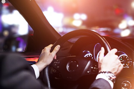 businessman driving a car at night