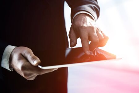 businessman holding and pusning digital  touch pad