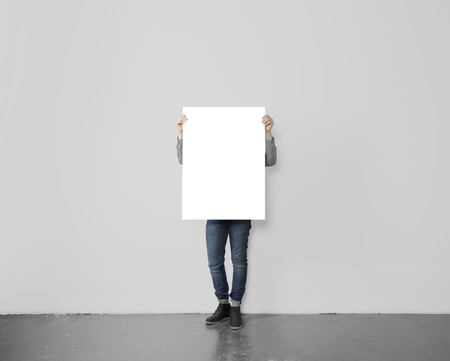 young hipster holding blank posterの写真素材