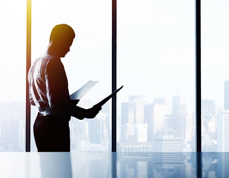 businessman with paper  in officeの写真素材