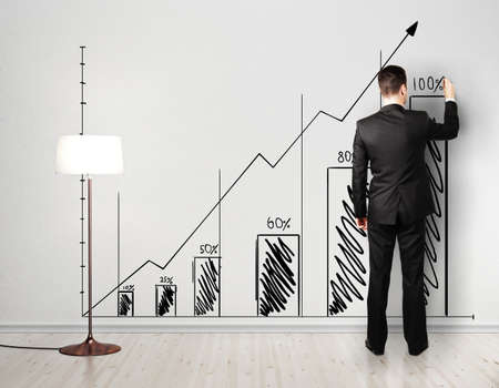 businessman drawing stock chart on wallの写真素材