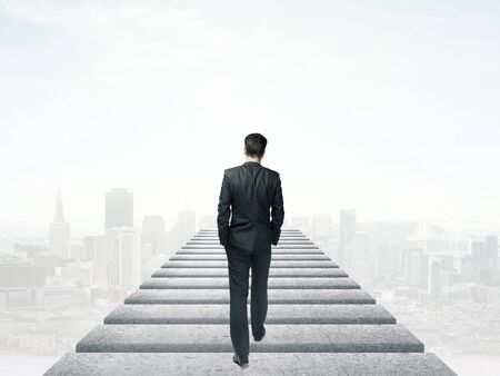 businessman walking in the sky and cityの写真素材