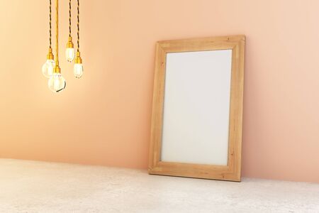 Sideview of blank picture frame and light bulbs in interior with peach wall and concrete floor. Mock...