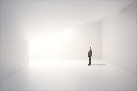 Sunlit interior design with blank white concrete wall and thoughtful caucasian businessman. Mock up, 3D Renderの写真素材