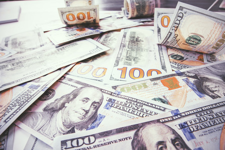 Lots of dollar bills scattered in chaotic orderの写真素材