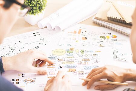 Business concept with businesspeople drawing schemes and diagrams on paper in officeの写真素材