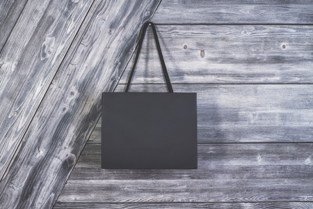 Blank shopping bag suspended on wooden wall.の写真素材