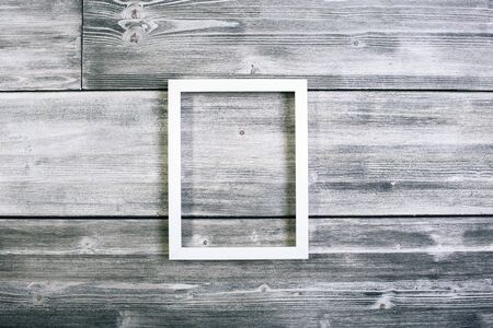 Long see-through frame hanging on antique wooden wall.の写真素材