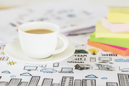 Closeup of coffee cup and colorful stickers on business concept sketchの写真素材