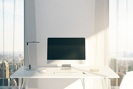Creative desktop with blank computer screen in sunlit office with windows and city view. Mock up, 3D Renderingの写真素材