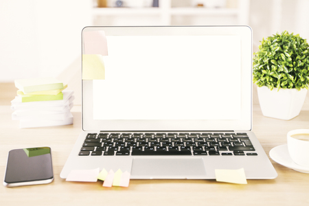 Blank laptop screen and phone on table with plant in off. Mock upの写真素材