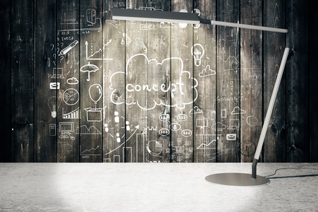 Table lamp illuminating wooden wall with business concept. 3D Renderingの写真素材
