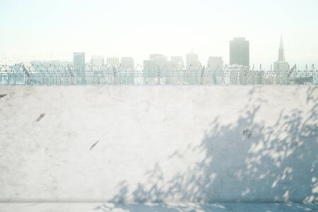 Concrete prison wall with shadows and city view. Mock up, 3D Renderingの写真素材