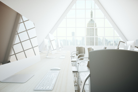 Closeup of workplace with computer monitor and keyboard in coworking office with New York city view. 3D Renderingの写真素材