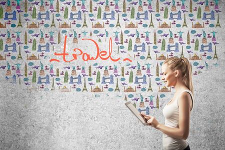 girl looking at new travel on tabletの写真素材