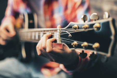 Closeup of blurry male hands playing the guitarの写真素材