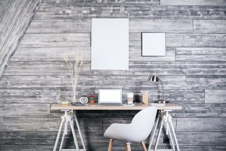 Interior with creative workplace, blank white laptop, stationery items, chair and blank picture...