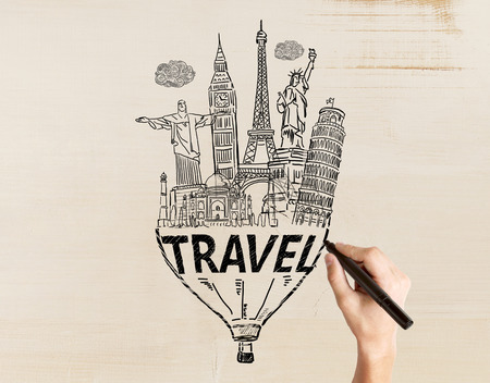 Travel concept with male hand drawing sketch on light textured backgroundの写真素材