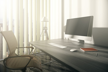 Closeup of workplace with swivel-chair, wooden desk, blank computer monitor and window with blinds and city view. Mock up, 3D Renderingの写真素材