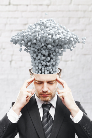 Brainstorming concept with thoughtful man and expoded brain with abstract smokeの写真素材