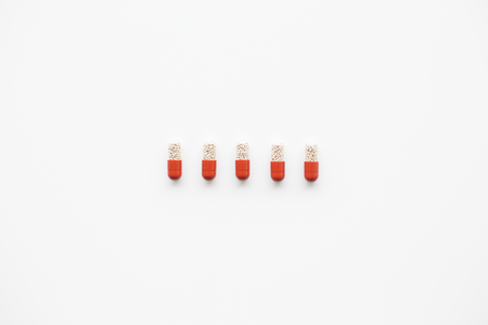 Row of capsules on bright white background