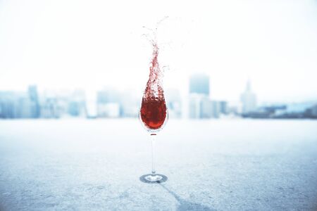 Concrete surface with splashing glass of wine on foggy city background. 3D Rendering