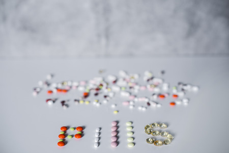 Light surface with pills and text on concrete wall backgroundの写真素材